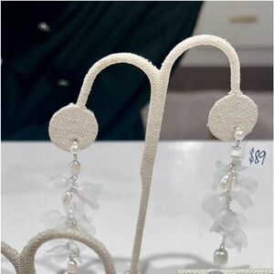 Dangle pearl earrings.